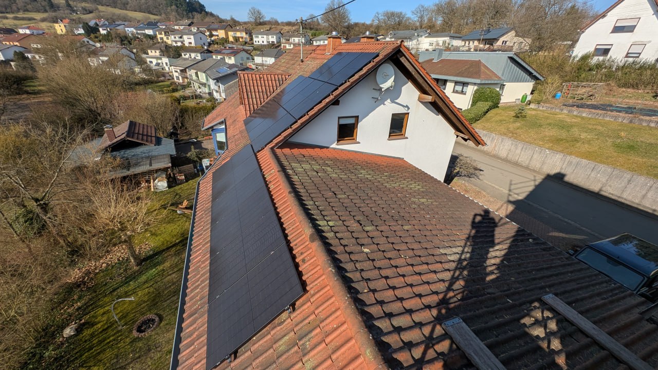 Solar panels on a terracotta tile roof in a small German village